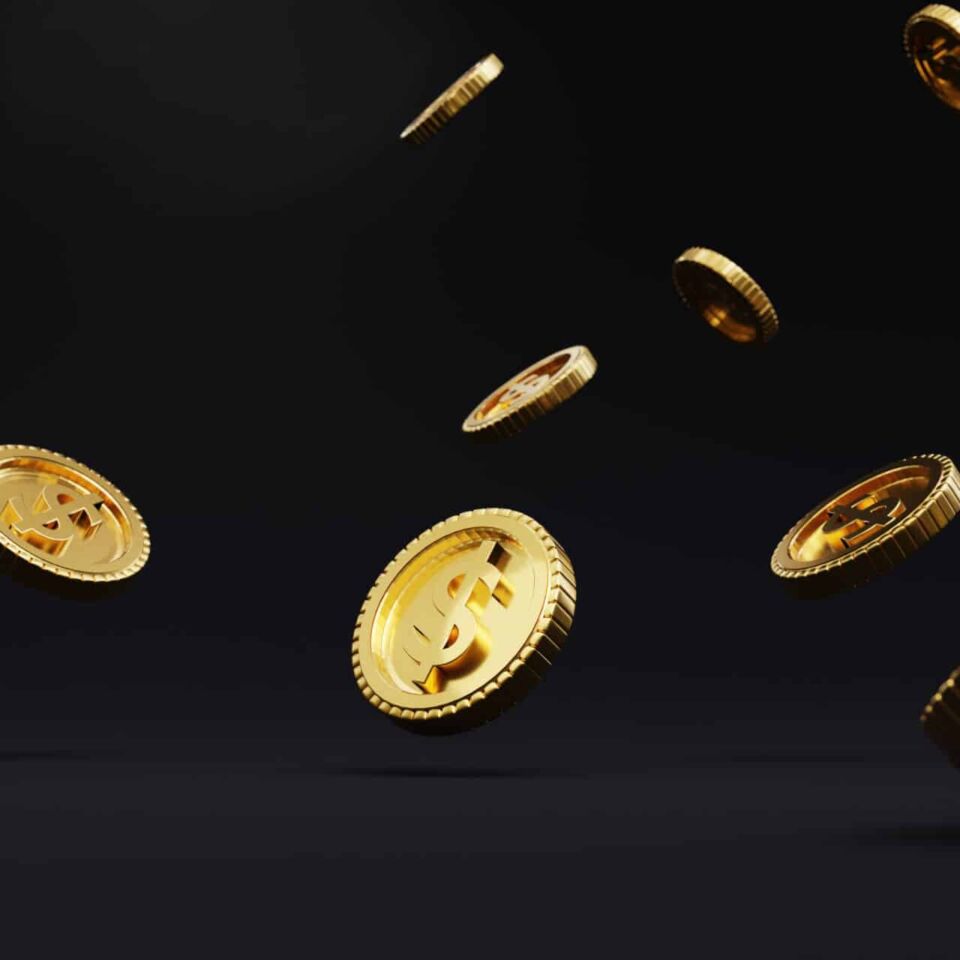Closeup of golden USD coins dropping on dark background , Dollar