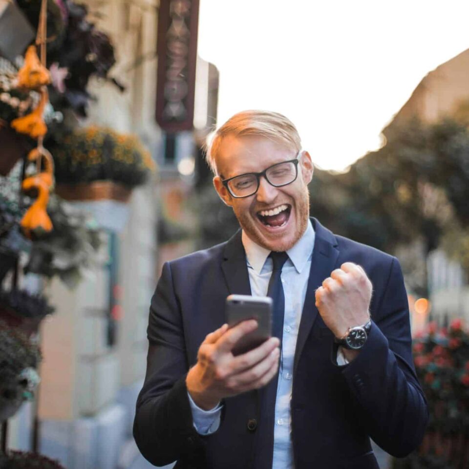 man celebrating phone cellular